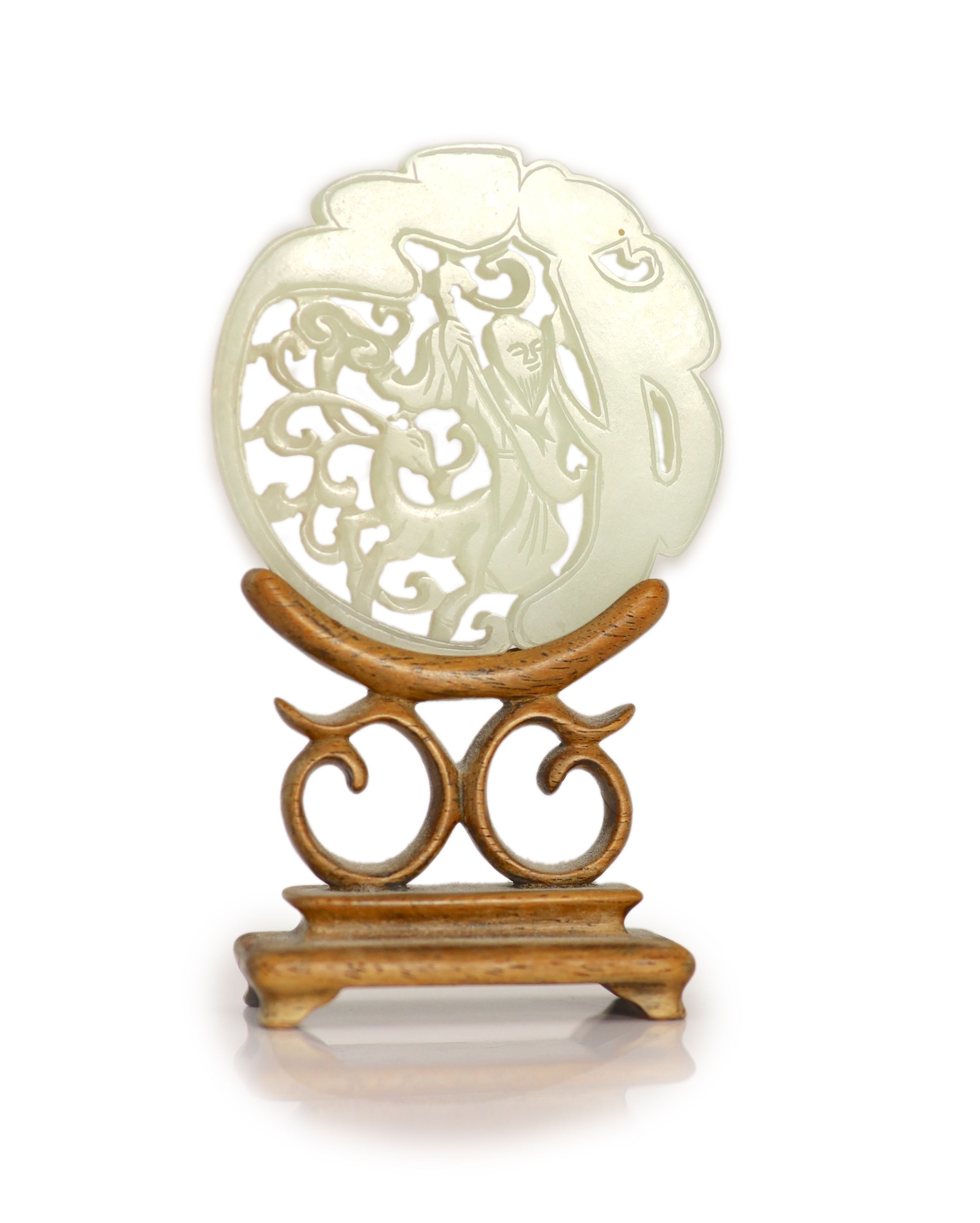 A Chinese pale celadon jade 'Shou Lao' circular plaque, 19th century, 5.3cm, wood stand